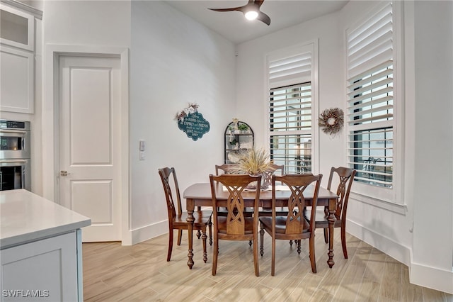 dining area featuring ceiling fan and light wood-type flooring