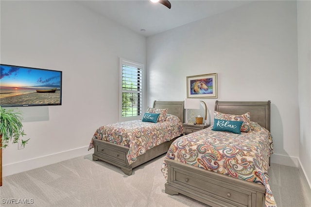 bedroom featuring light carpet and ceiling fan