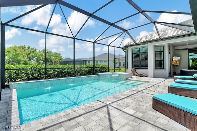 view of pool featuring pool water feature, glass enclosure, an in ground hot tub, and a patio