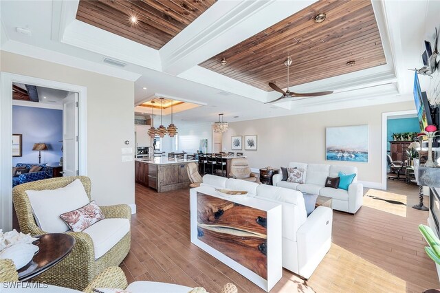 living room with ceiling fan, light hardwood / wood-style floors, a raised ceiling, and wood ceiling