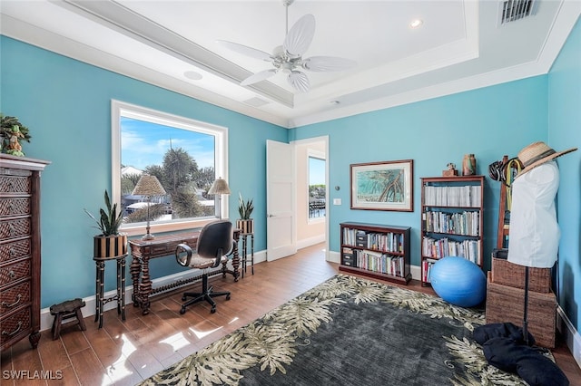 office area featuring a tray ceiling and ceiling fan