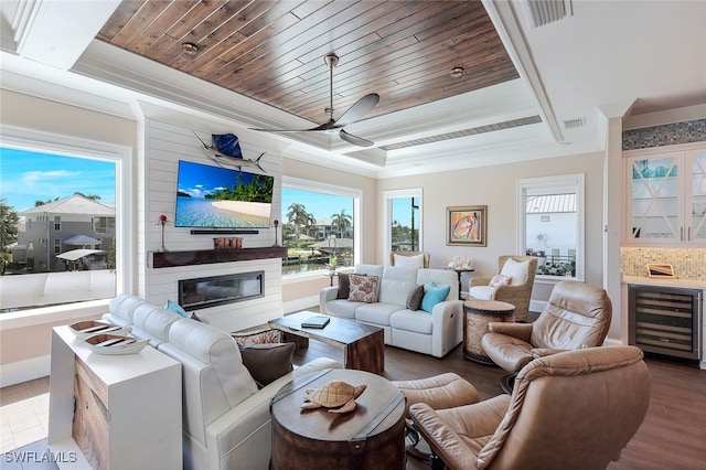 living room featuring a large fireplace, wine cooler, hardwood / wood-style flooring, a raised ceiling, and wooden ceiling