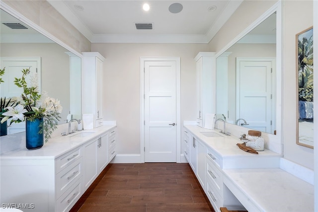 mudroom with crown molding, sink, and dark wood-type flooring