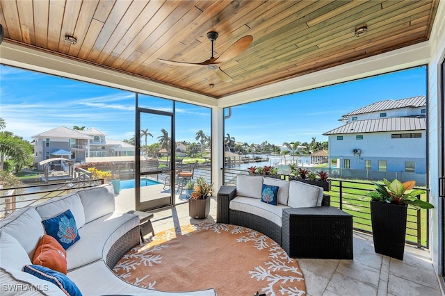 interior space featuring wooden ceiling, ceiling fan, and a water view