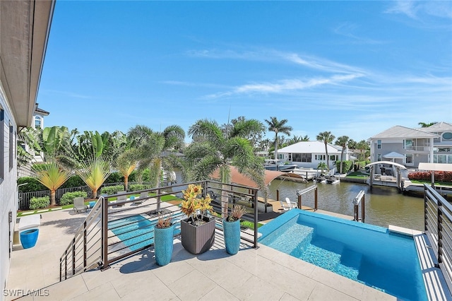 view of pool with a water view, a dock, and a patio