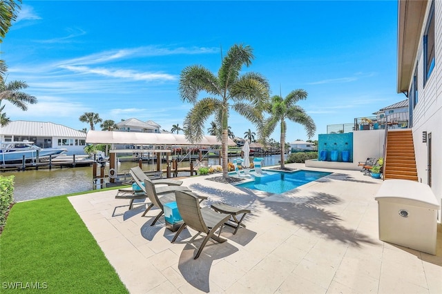 view of pool with a dock, a water view, and a patio