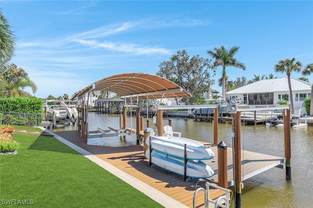 view of dock featuring a water view and a lawn