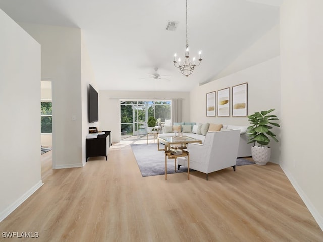 living room featuring high vaulted ceiling, ceiling fan with notable chandelier, and light wood-type flooring