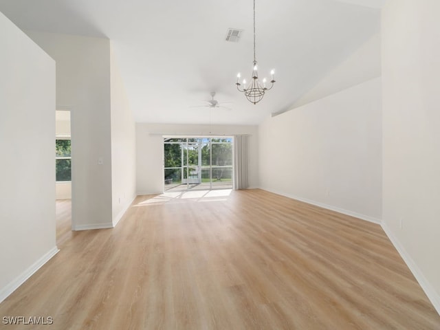 interior space featuring ceiling fan with notable chandelier, light hardwood / wood-style floors, and high vaulted ceiling