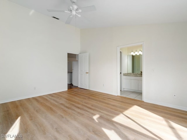 unfurnished bedroom featuring ensuite bathroom, ceiling fan, and light hardwood / wood-style floors