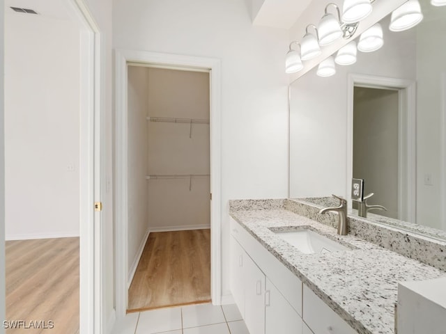 bathroom featuring tile patterned flooring and vanity