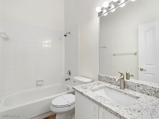 full bathroom with vanity, tiled shower / bath combo, and toilet