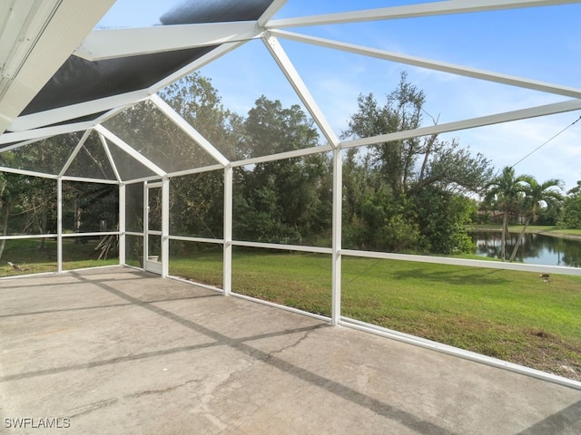 exterior space with glass enclosure and a water view