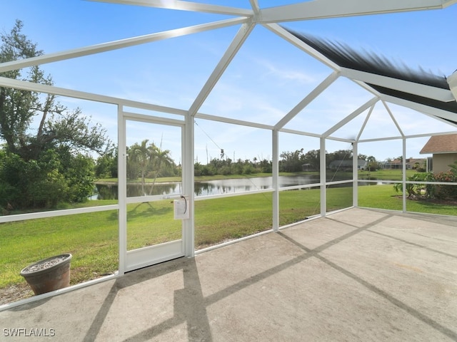 unfurnished sunroom featuring a water view