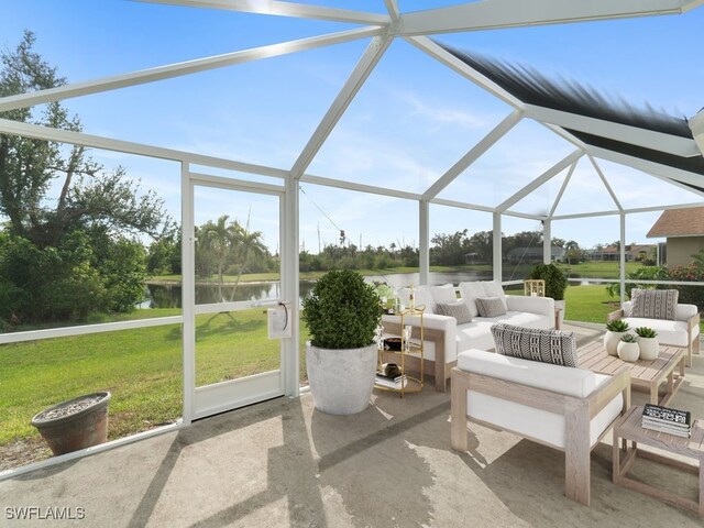 view of patio / terrace featuring a lanai, a water view, and an outdoor hangout area