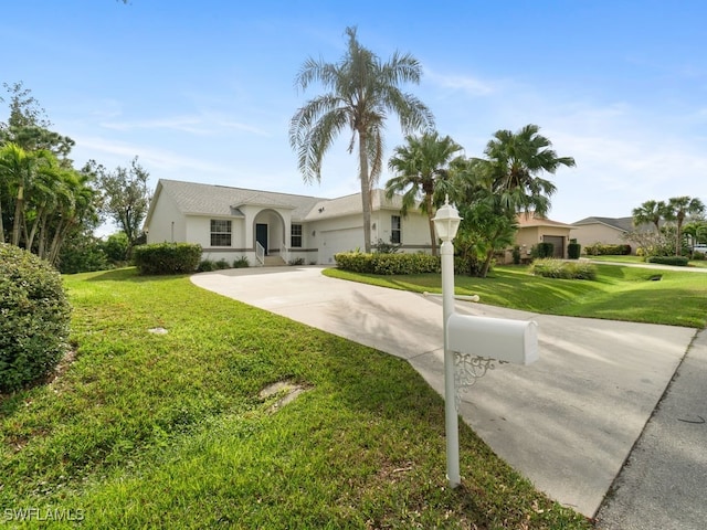 view of front of property featuring concrete driveway, a front lawn, an attached garage, and stucco siding