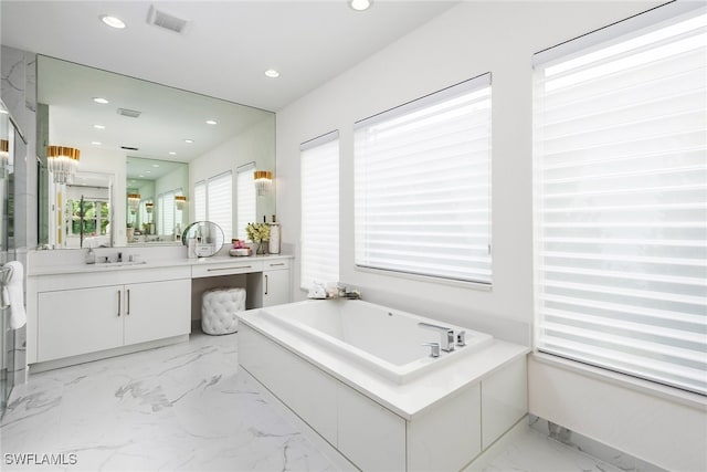 bathroom with vanity and a washtub