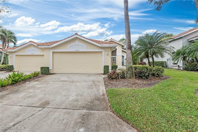 view of front of property with a garage and a front lawn