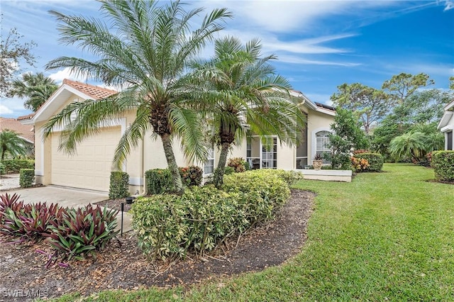 view of front of home featuring a front yard and a garage