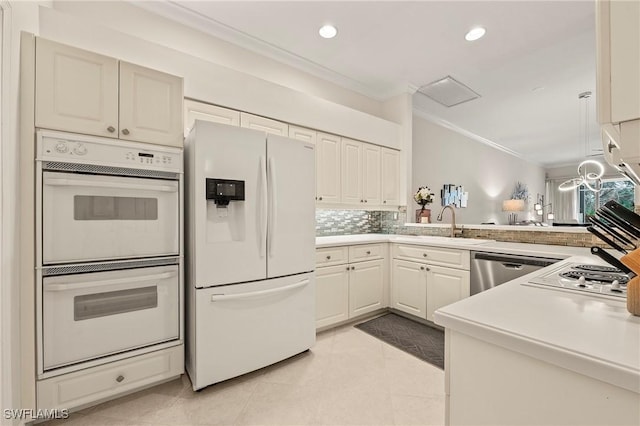 kitchen with white appliances, sink, light tile patterned floors, ornamental molding, and kitchen peninsula