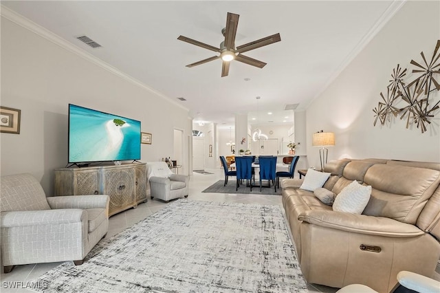 living room featuring crown molding, ceiling fan, and light tile patterned floors