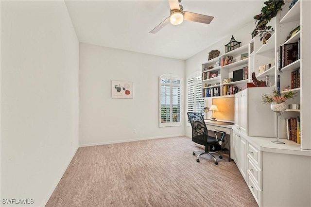 carpeted office with ceiling fan