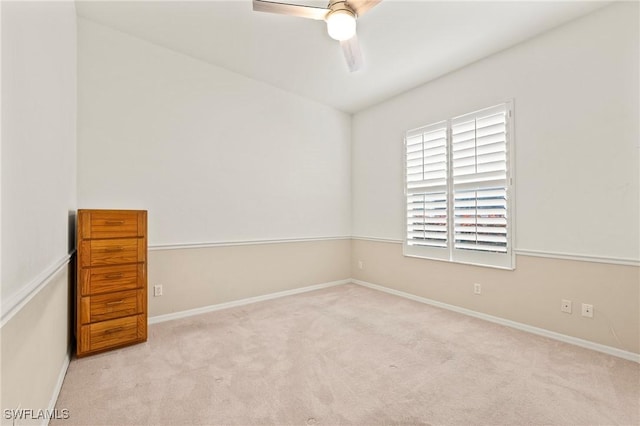 empty room featuring ceiling fan and light colored carpet