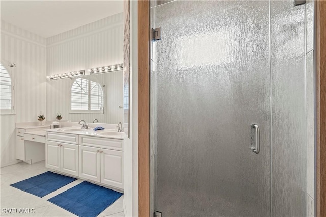 bathroom featuring tile patterned flooring, vanity, and walk in shower