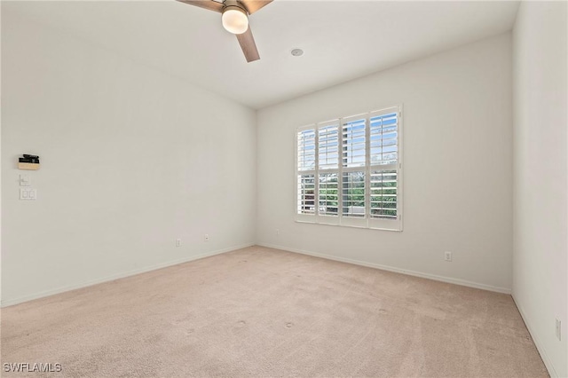 unfurnished room with light carpet and ceiling fan