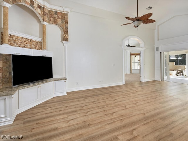 unfurnished living room with a ceiling fan, visible vents, light wood-style flooring, and baseboards