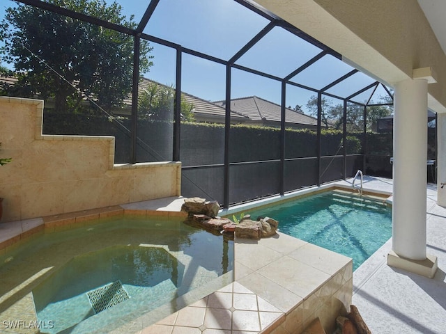 outdoor pool featuring an in ground hot tub and a lanai