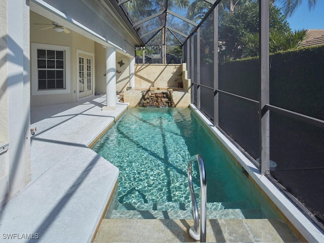 view of swimming pool featuring a fenced in pool, a ceiling fan, a patio, a fenced backyard, and a lanai