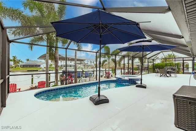 view of pool with a lanai, a patio area, and an in ground hot tub