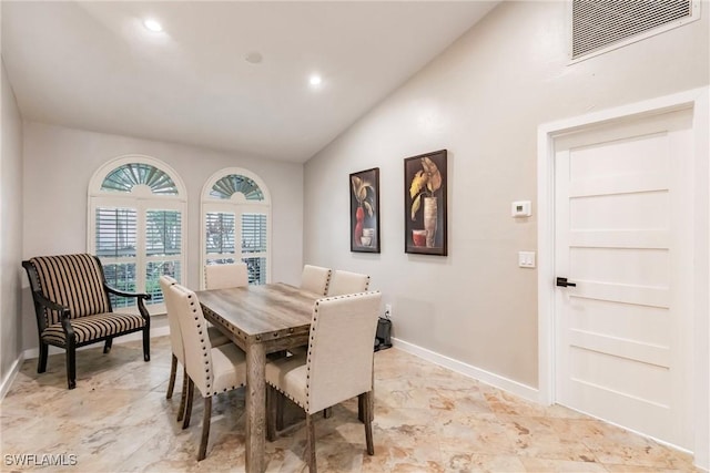 dining room with lofted ceiling