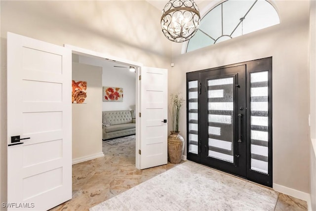 foyer entrance featuring french doors and a notable chandelier