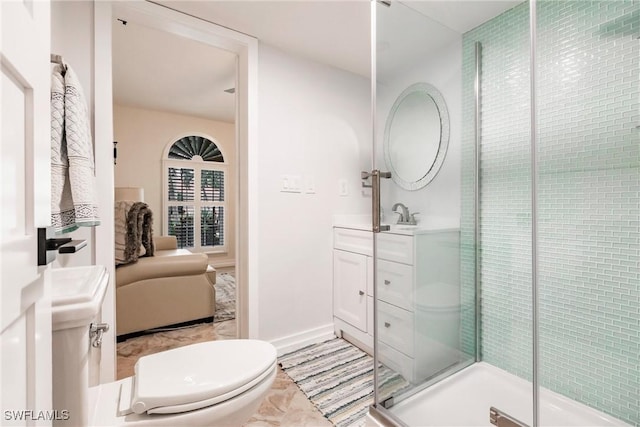 bathroom with an enclosed shower, vanity, and toilet