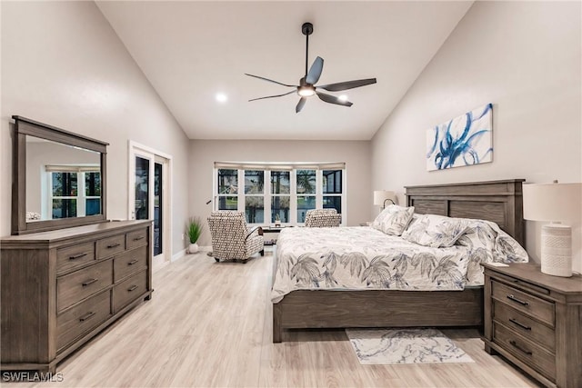 bedroom with ceiling fan, lofted ceiling, and light hardwood / wood-style flooring