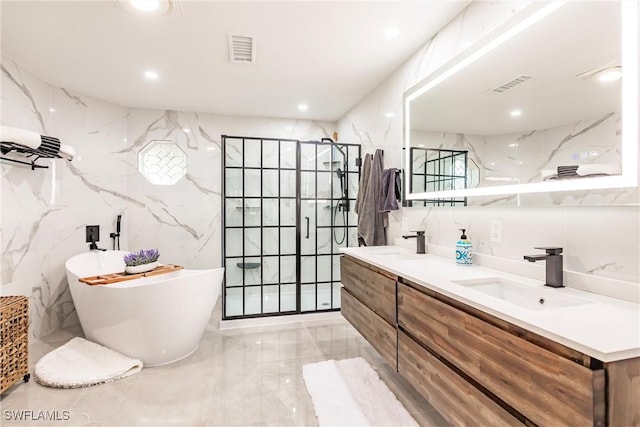 bathroom featuring tile walls, vanity, and shower with separate bathtub