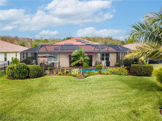 rear view of property with a lanai and a yard