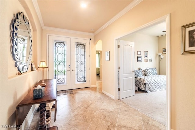 foyer with french doors, light colored carpet, and crown molding