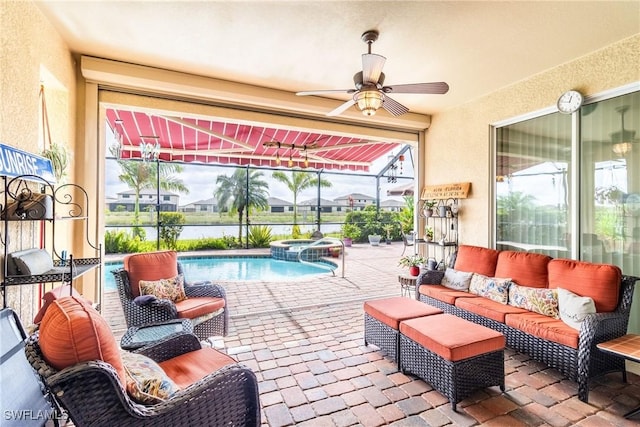 view of patio / terrace featuring outdoor lounge area, ceiling fan, a lanai, and an in ground hot tub