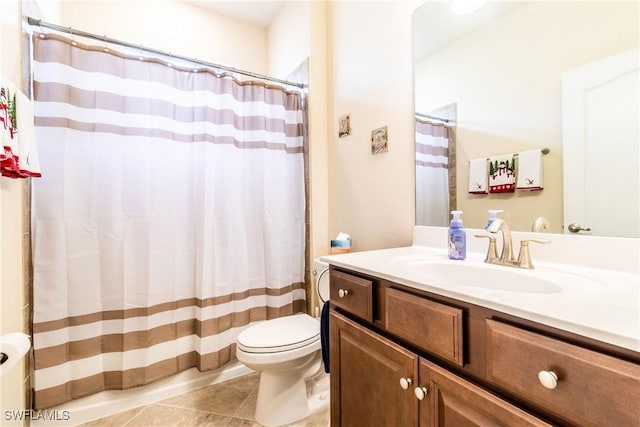 bathroom featuring tile patterned flooring, vanity, and toilet