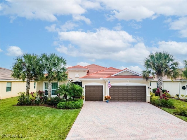 view of front of home with a garage and a front lawn