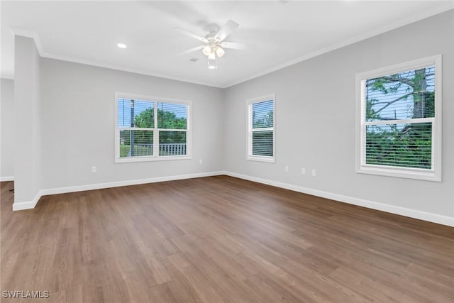 spare room featuring ceiling fan, ornamental molding, wood finished floors, and baseboards