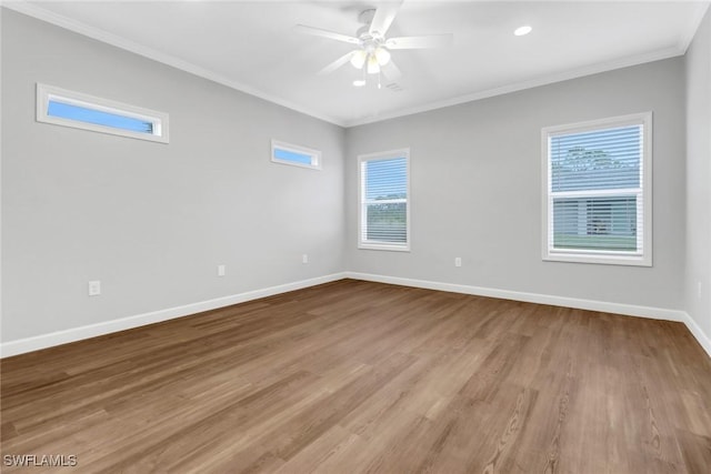 837 Da Vinci Ave S, Lehigh Acres, FL 33974 - empty room with crown molding, light wood-type flooring, a wealth of natural light, and baseboards