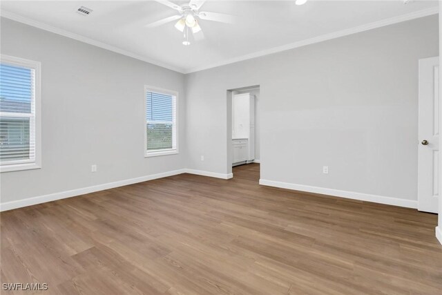 837 Da Vinci Ave S, Lehigh Acres, FL 33974 - empty room featuring light wood-style floors, baseboards, visible vents, and crown molding