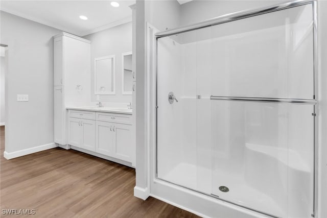 837 Da Vinci Ave S, Lehigh Acres, FL 33974 - bathroom featuring baseboards, wood finished floors, vanity, a shower stall, and recessed lighting