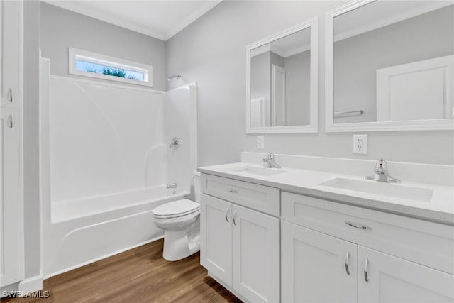 full bathroom with washtub / shower combination, a sink, toilet, and wood finished floors