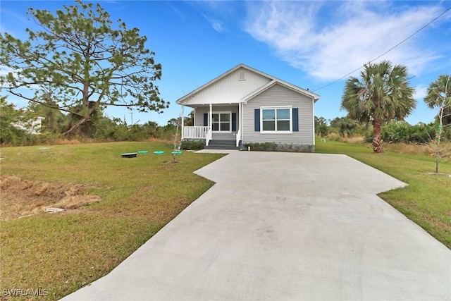 view of front facade featuring a porch, concrete driveway, and a front lawn