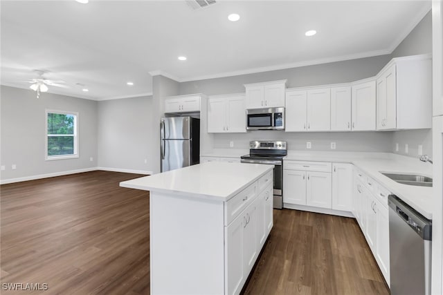837 Da Vinci Ave S, Lehigh Acres, FL 33974 - kitchen featuring a center island, light countertops, appliances with stainless steel finishes, open floor plan, and white cabinetry